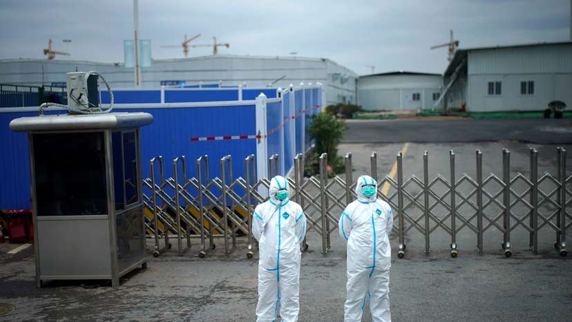 FILE PHOTO: Workers in protective suits are seen at the Leishenshan Hospital, a makeshift hospital for treating patients with the coronavirus disease (COVID-19), in Wuhan