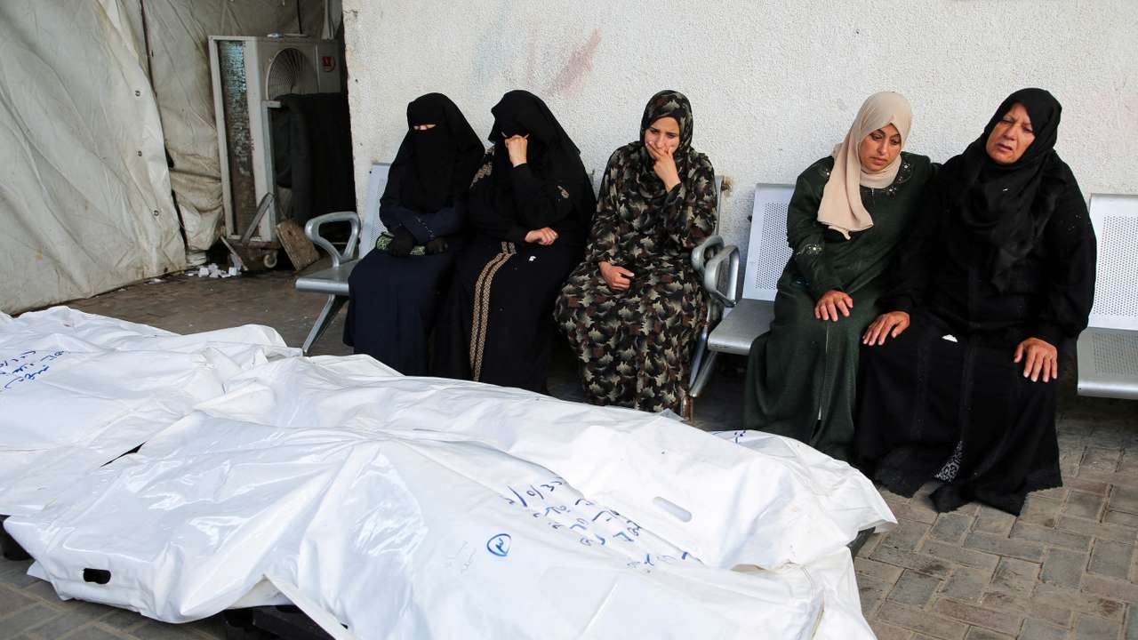 Mourners react next to the bodies of Palestinians killed in an Israeli strike, in Rafah, southern Gaza Strip