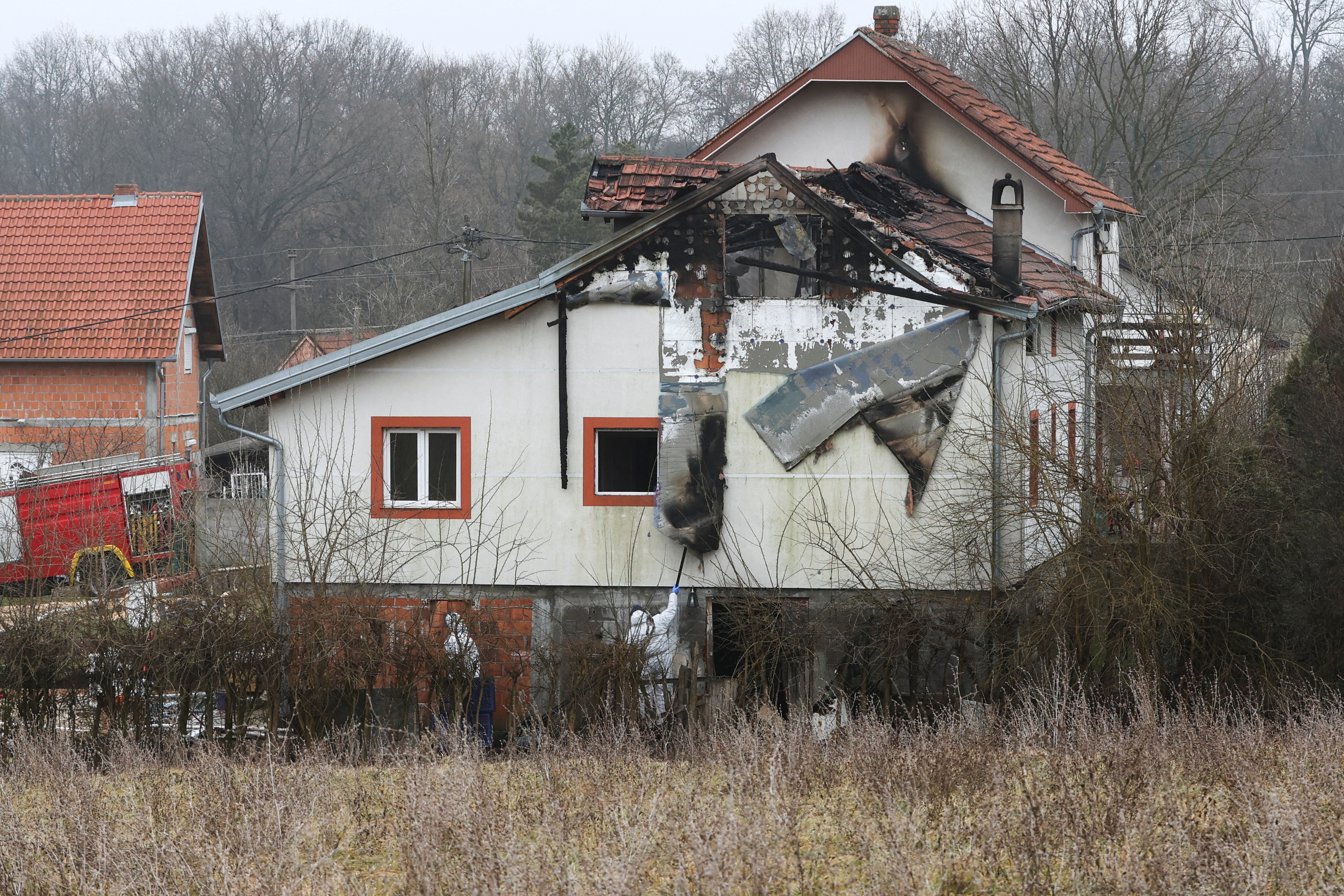 Emergency personnel work at a damaged nursing home that caught fire, outside Belgrade