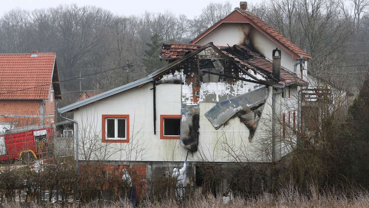 Emergency personnel work at a damaged nursing home that caught fire, outside Belgrade
