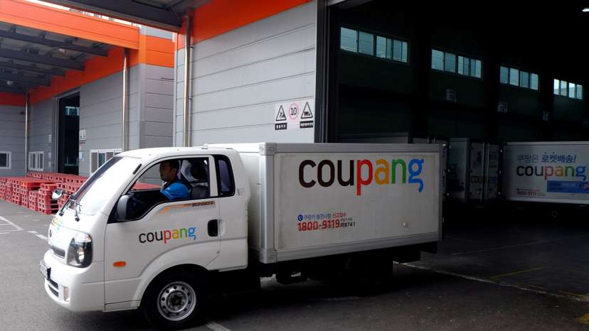 FILE PHOTO: Delivery trucks for e-commerce retailer Coupang leave a distribution centre in Seoul