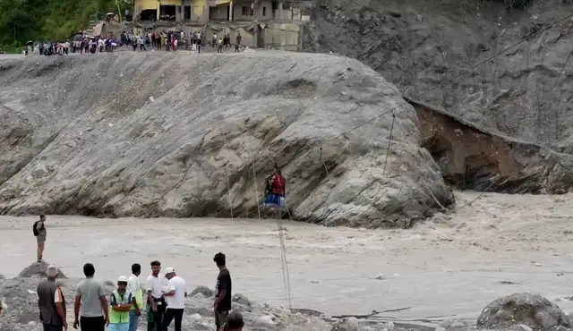 Nepalis cross river with zipline