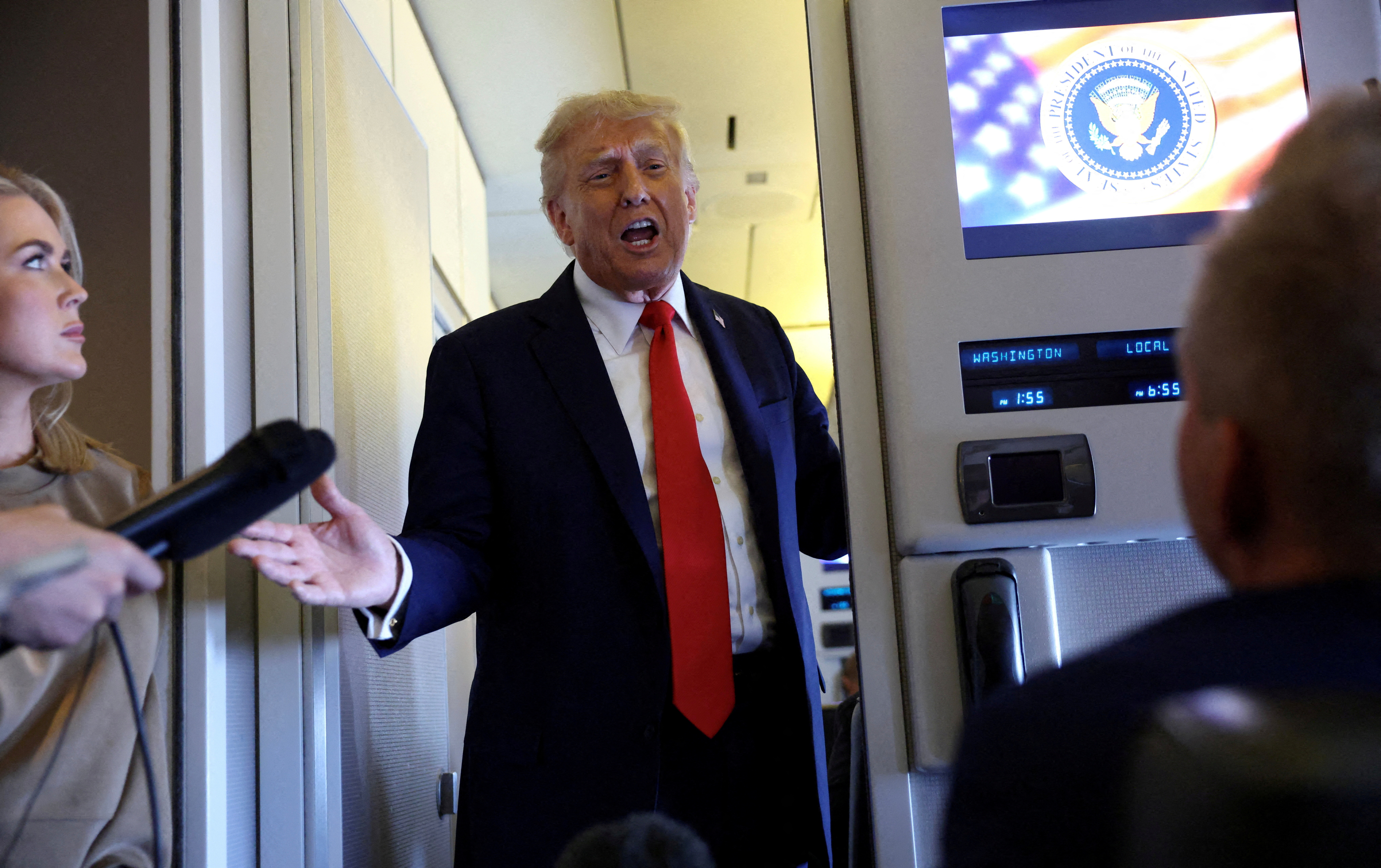 FILE PHOTO: Trump speaks aboard Air Force One on his return from a state visit in Britain