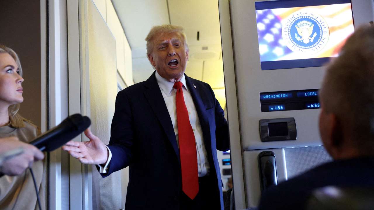FILE PHOTO: Trump speaks aboard Air Force One on his return from a state visit in Britain