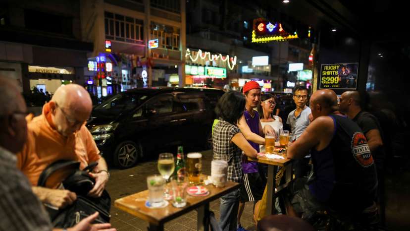 FILE PHOTO: People have a drink inside a bar in Hong Kong, China