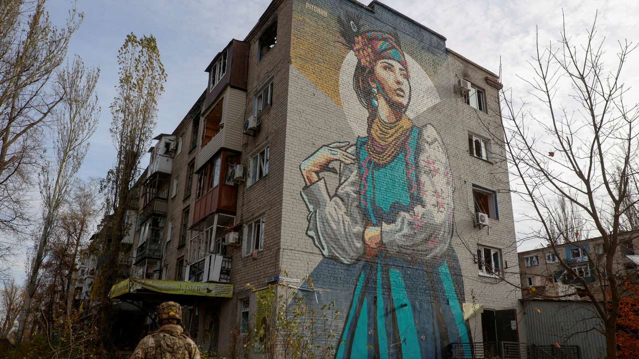 FILE PHOTO: Ukrainian serviceman walks next to a residential building heavily damaged by permanent Russian military strikes in the front line town of Avdiivka