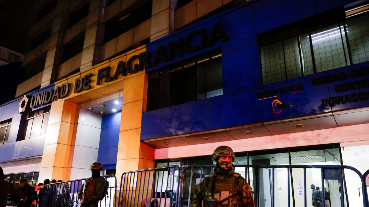 Police and military officials stand outside the Flagrancy Unit, where former Ecuador Vice President Jorge Glas is believed to be detained, in Quito