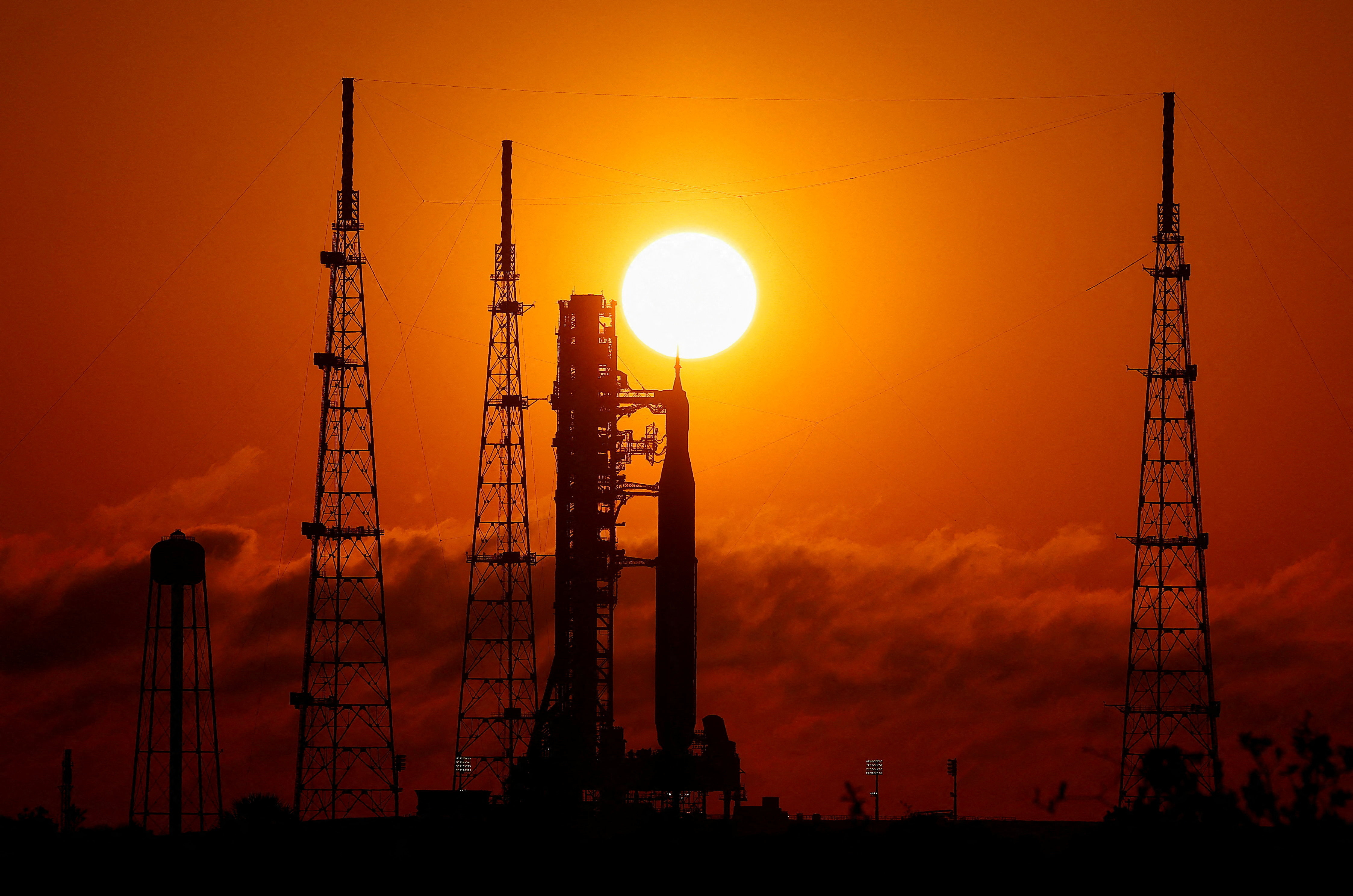 NASA's next-generation moon rocket, the Space Launch System (SLS) rocket with the Orion crew capsule, on launch pad 39B as the sun rises