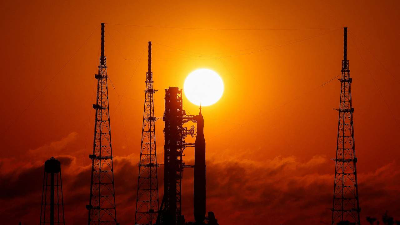 NASA's next-generation moon rocket, the Space Launch System (SLS) rocket with the Orion crew capsule, on launch pad 39B as the sun rises