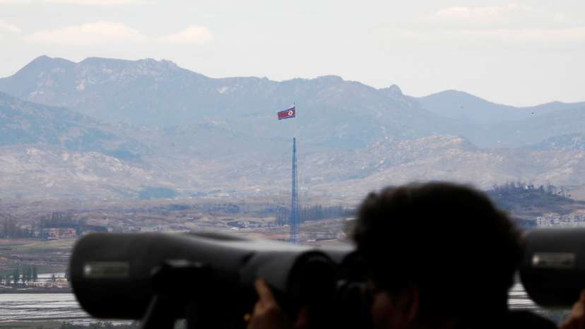 A North Korean flag flutters on top of a 160-metre tower in North Korea's propaganda village of Gijungdong in this picture taken from the Dora observatory near the demilitarised zone separating the two Koreas, in Paju