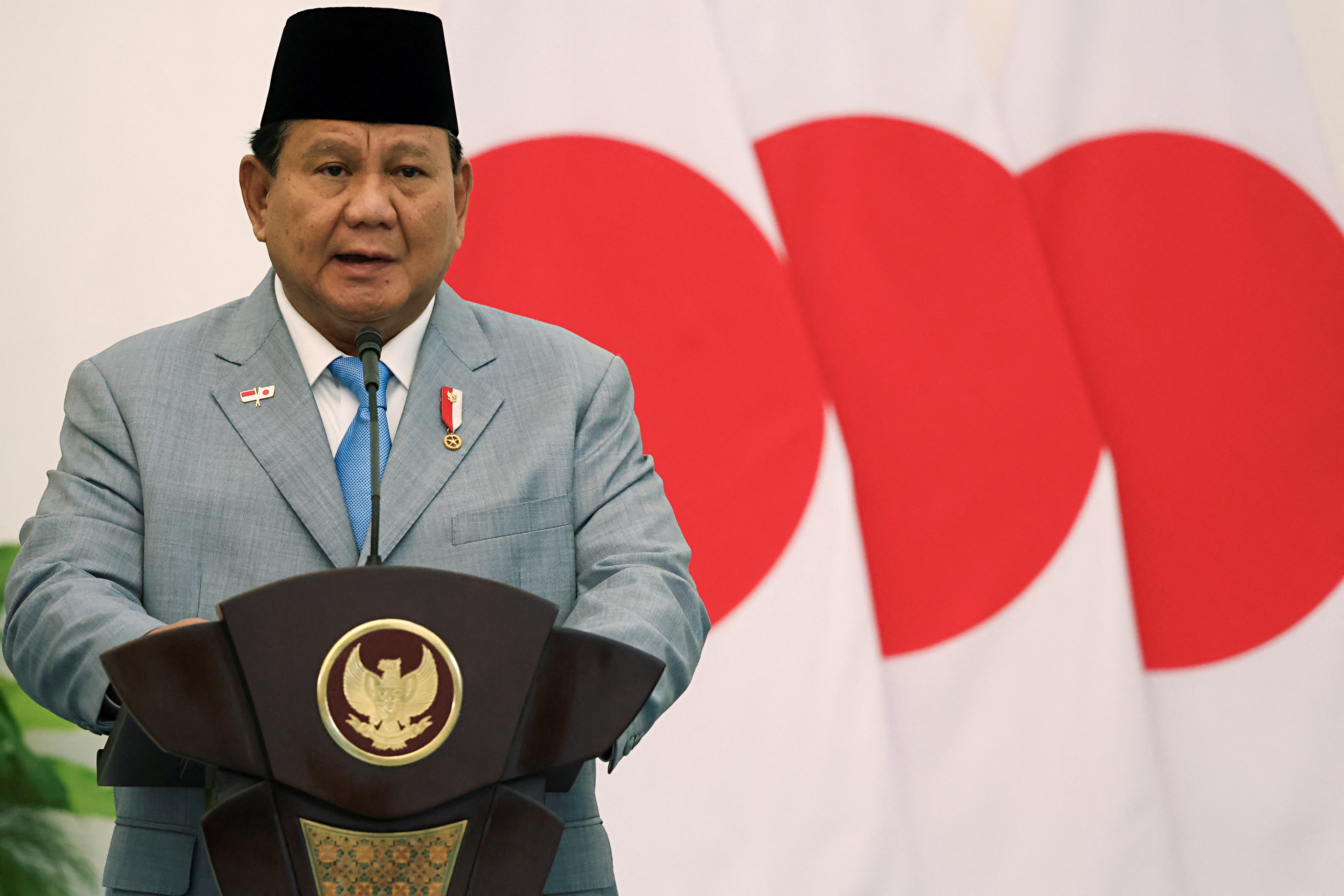 Indonesian President Prabowo Subianto delivers his speech during a press conference at the Presidential Palace in Bogor