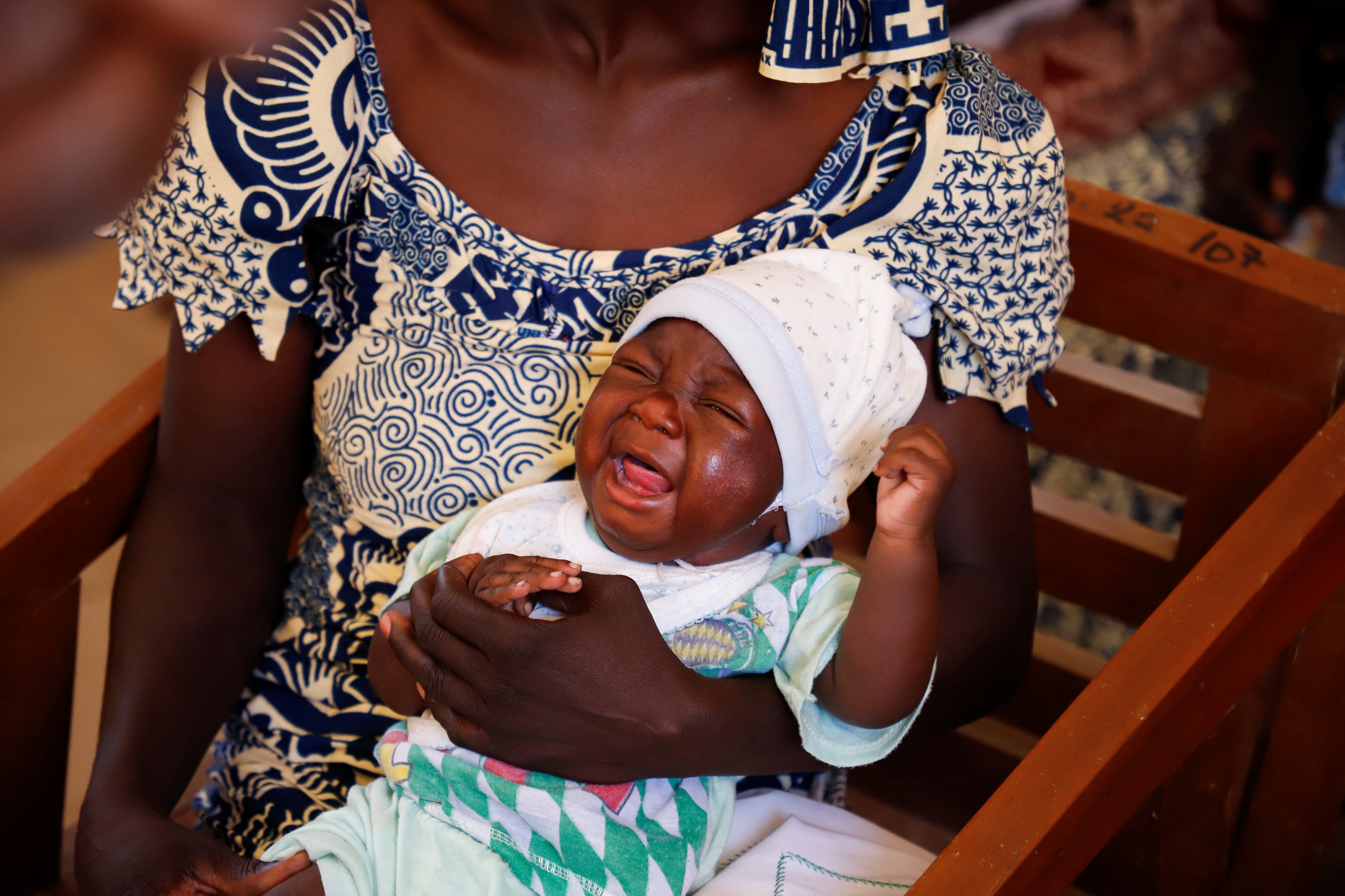 A child reacts after receiving a vaccine against Malaria at the health centre