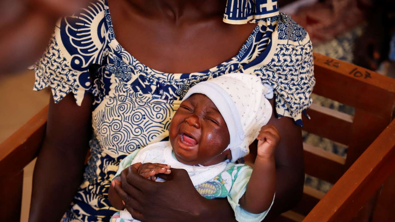 A child reacts after receiving a vaccine against Malaria at the health centre