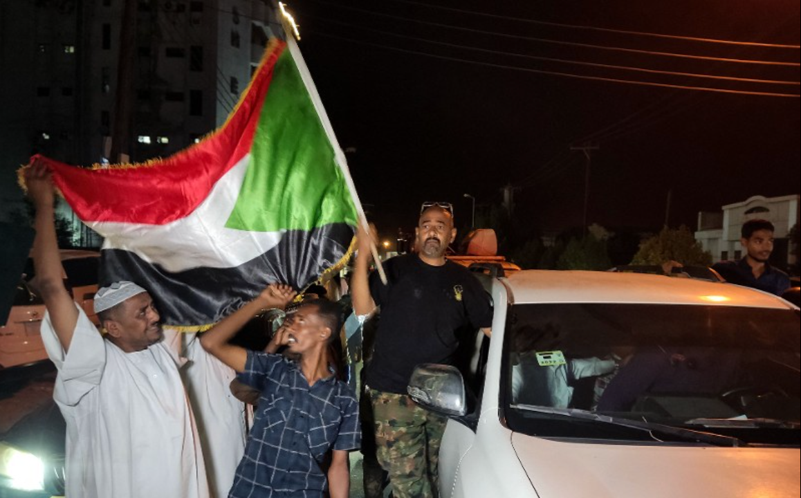 People celebrate on the streets of Port Sudan on March 21, 2025, after the army retook the presidential palace in Khartoum from paramilitaries.