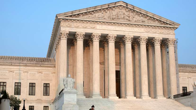 FILE PHOTO: A woman sits on the steps of the U.S. Supreme Court