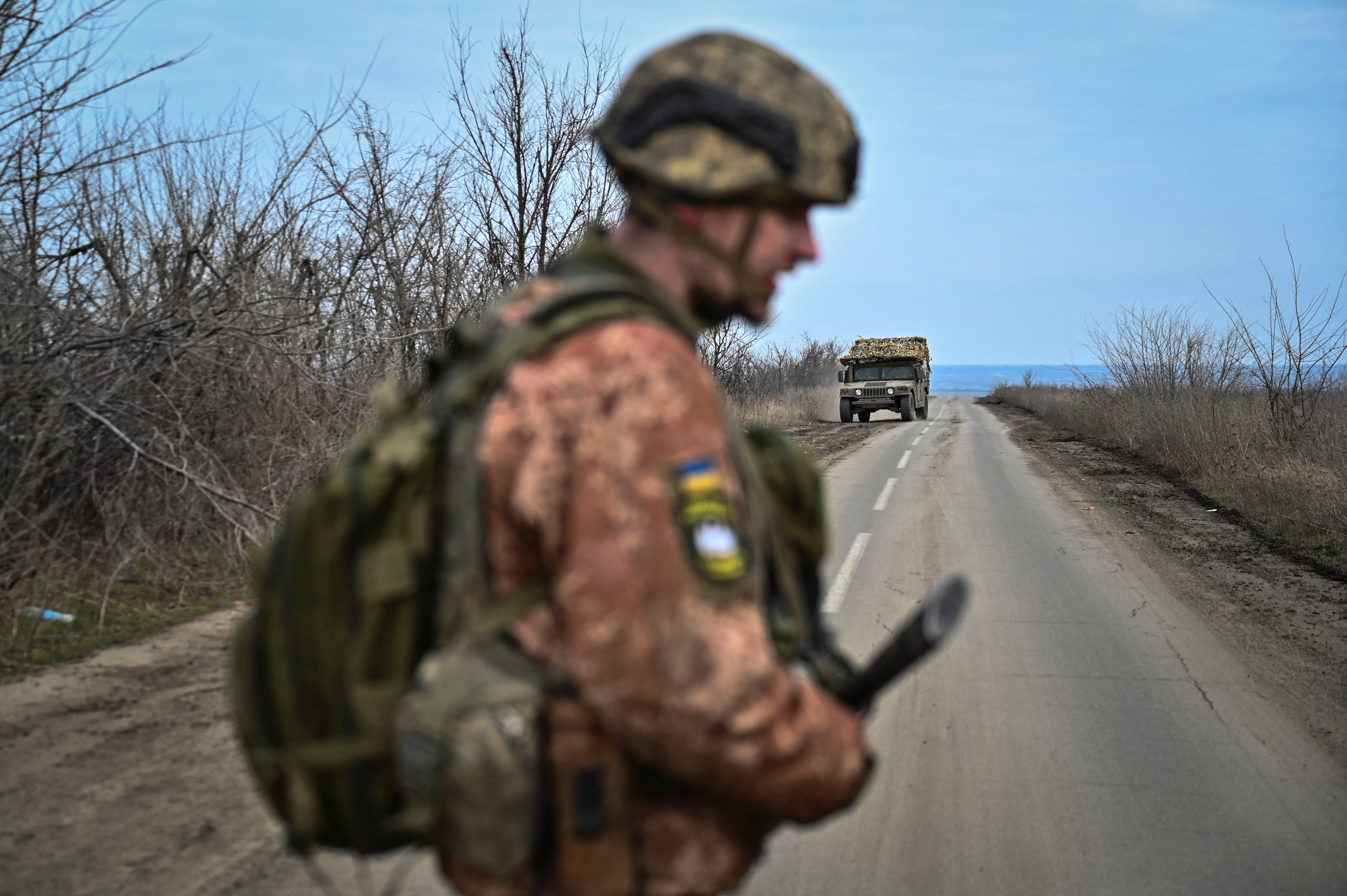 Ukrainian serviceman stands on a road near the front line village of Robotyne in Zaporizhzhia region