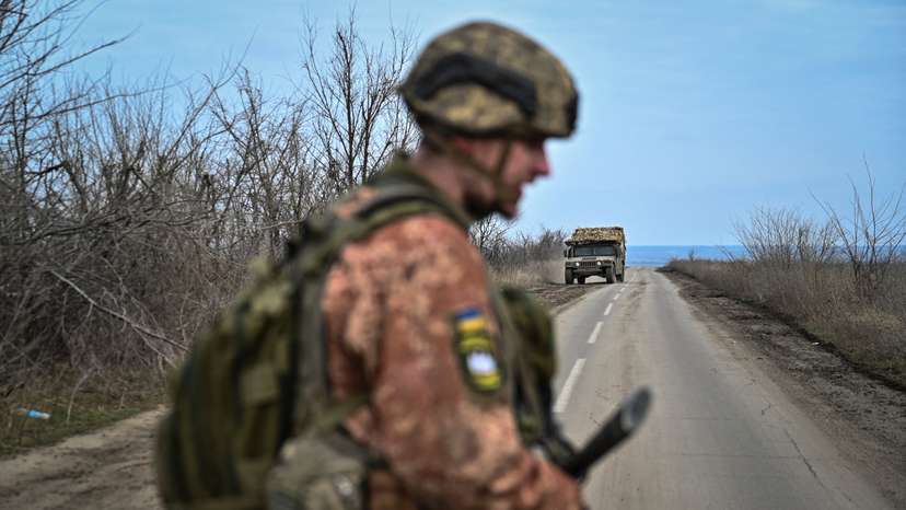 Ukrainian serviceman stands on a road near the front line village of Robotyne in Zaporizhzhia region