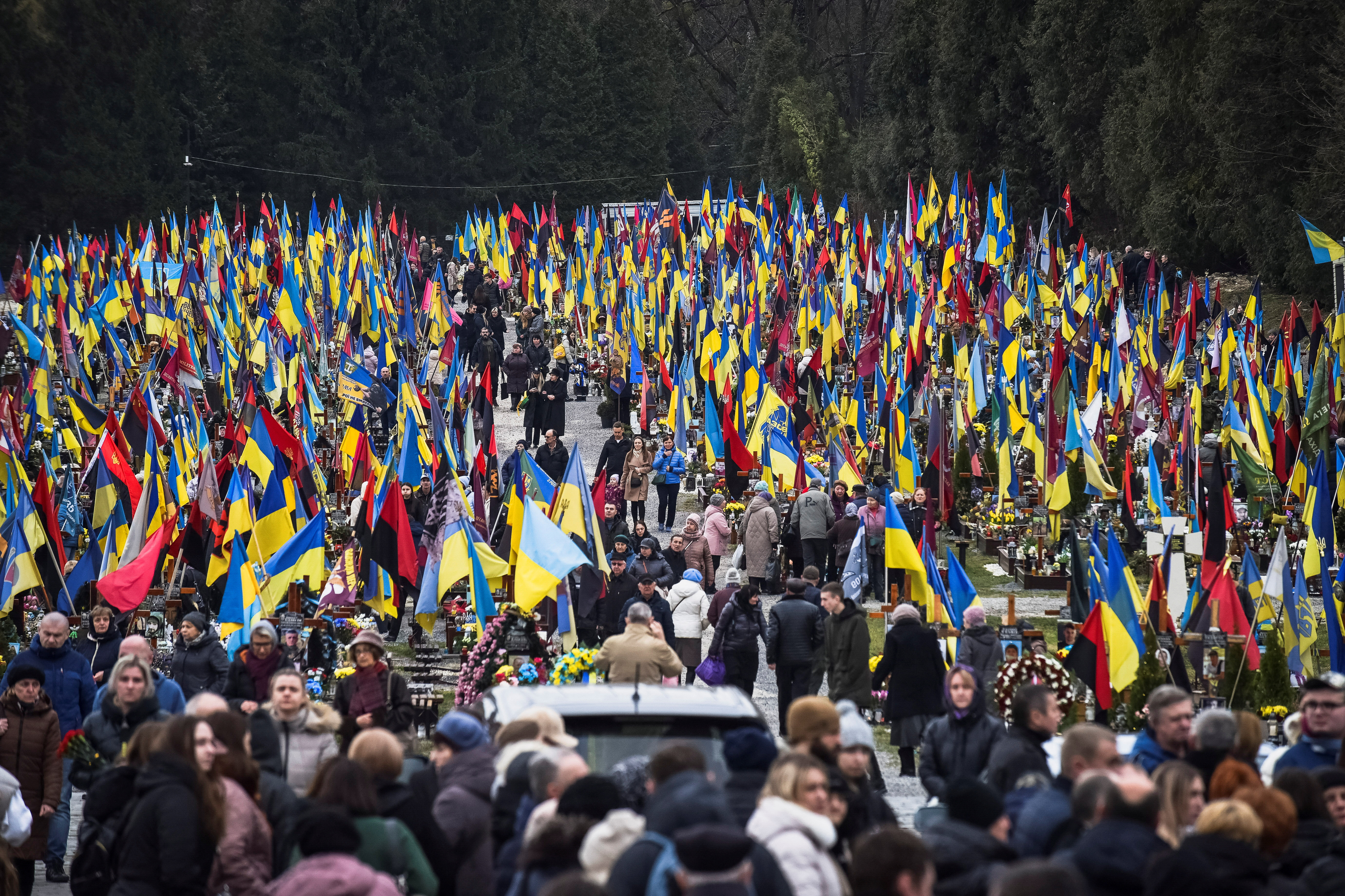 People visit graves of killed Ukrainian defenders, on the day of the second anniversary of Russia's attack on Ukraine, in Lviv