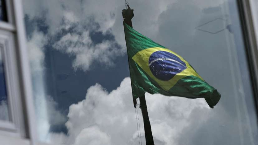 Brazil's flag is reflected in a window at the Planalto Palace, almost one year after the protest of January 8 in Brasilia