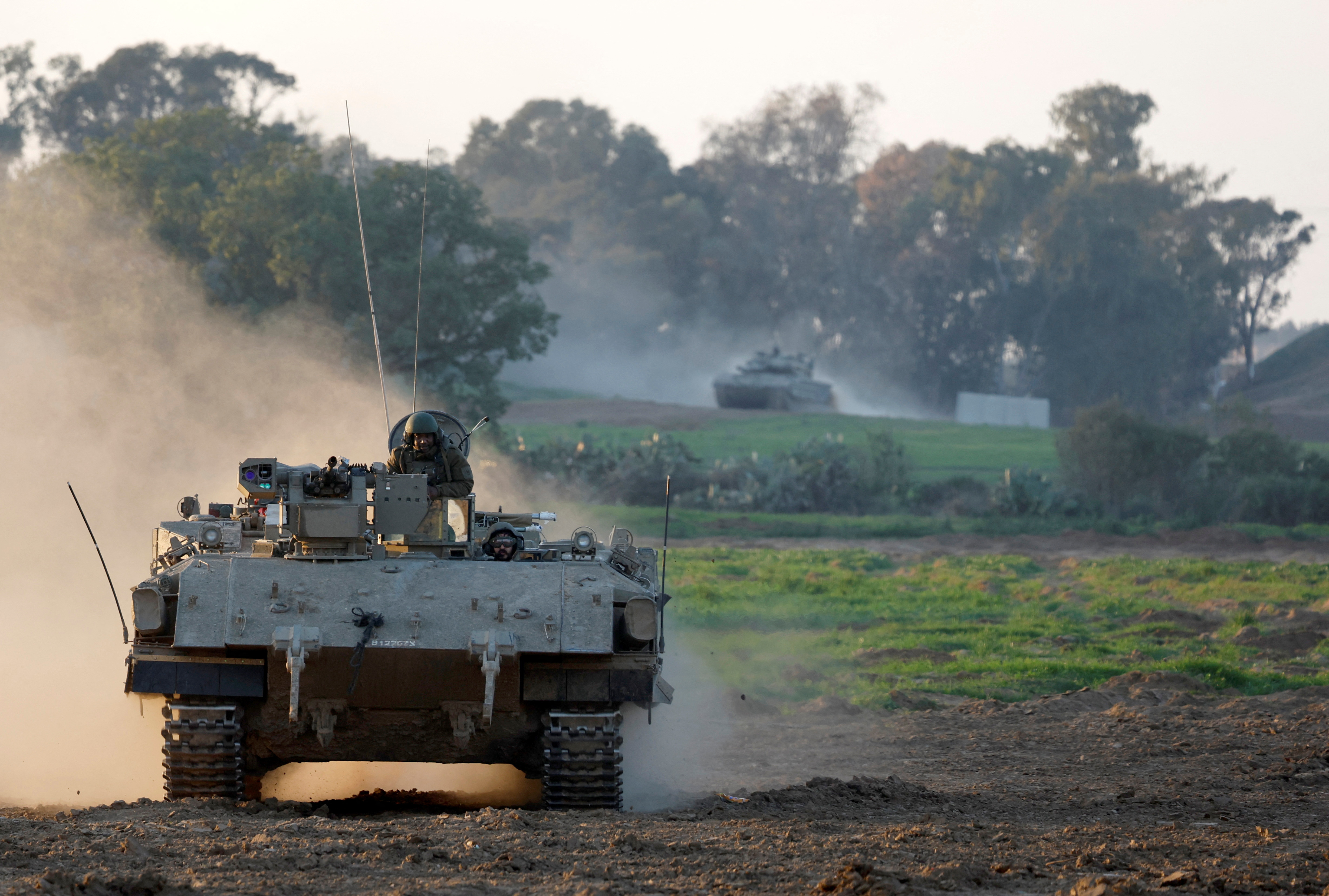 An Israeli APC enters Israel from Gaza, at the Israel-Gaza border