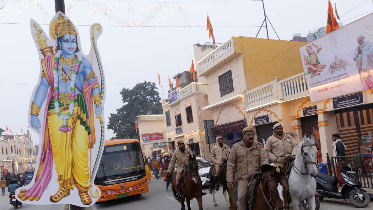 Police officers patrol a street on horseback ahead of the opening of the temple of Hindu Lord Ram in Ayodhya