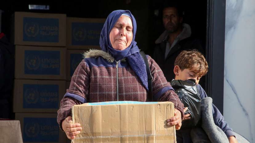 Palestinians receive aid from UNRWA in Khan Younis in the southern Gaza Strip