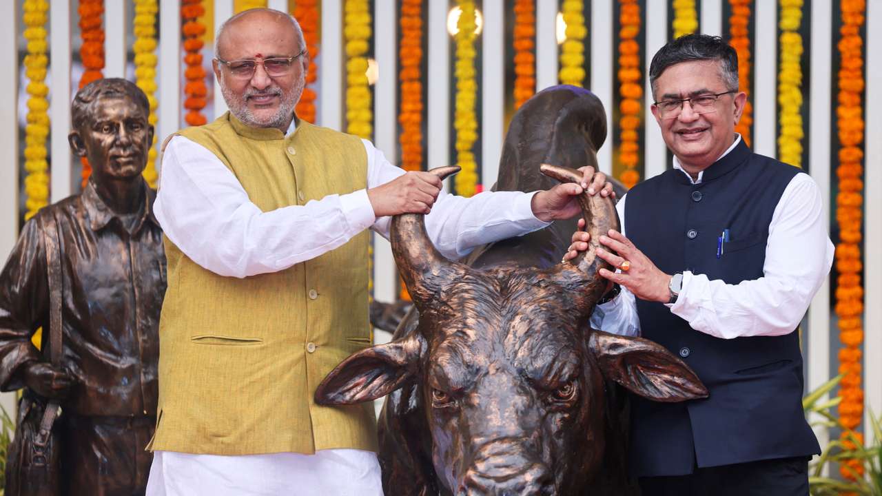 Governor of Maharashtra CP Radhakrishnan and MD and CEO National Stock Exchange (NSE) Ashish Chauhan pose for pictures at the inauguration of the bull statue at the National Stock Exchange (NSE), in Mumbai