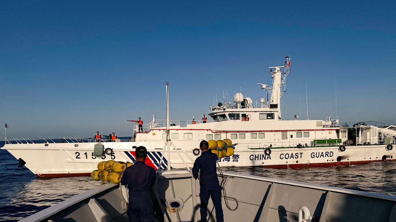 FILE PHOTO: Philippine Coast Guard personnel prepare rubber fenders after Chinese Coast Guard vessels blocked their way to a resupply mission at the Second Thomas Shoal in the South China