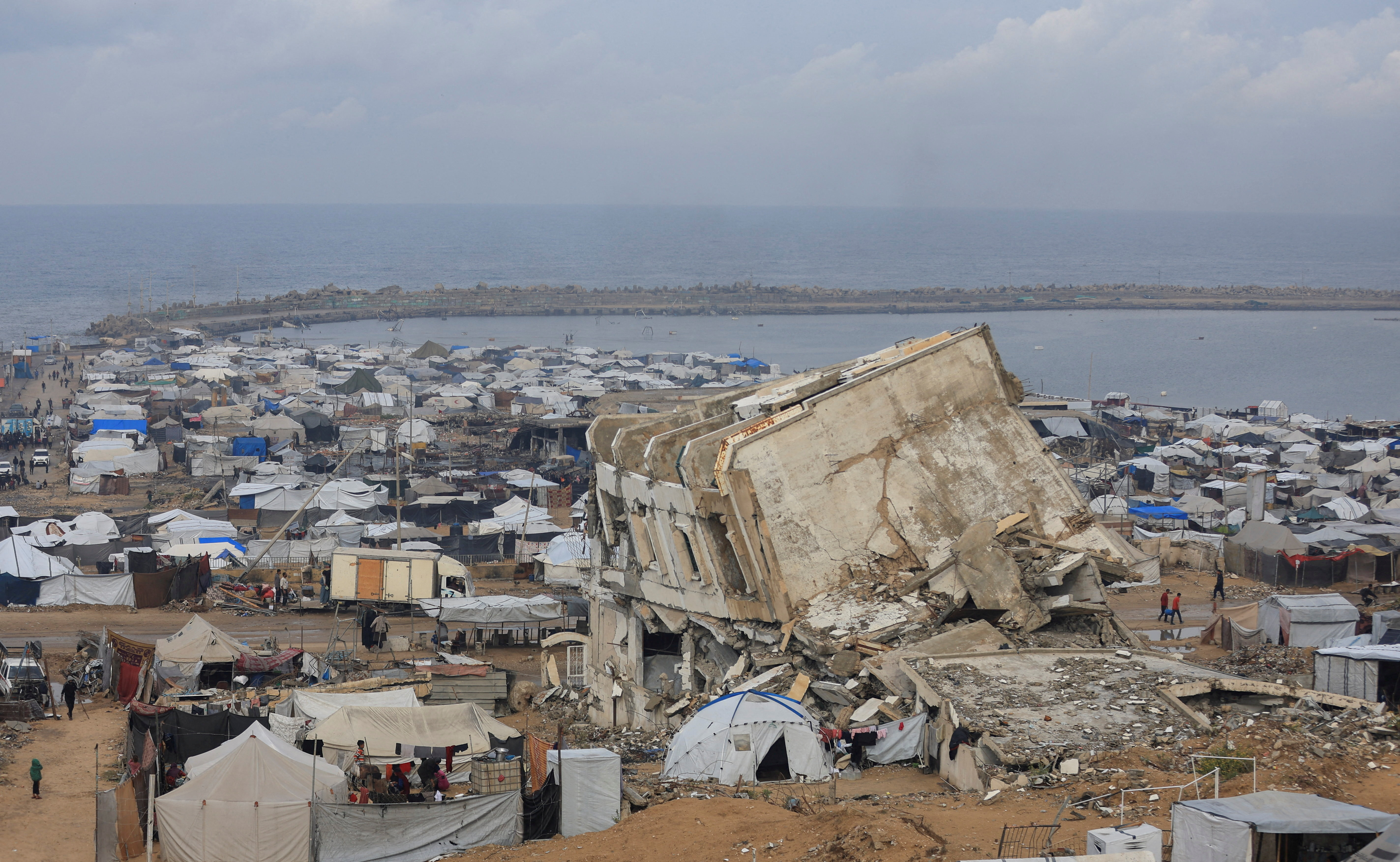 Palestinians shelter in tents during rain in Gaza City
