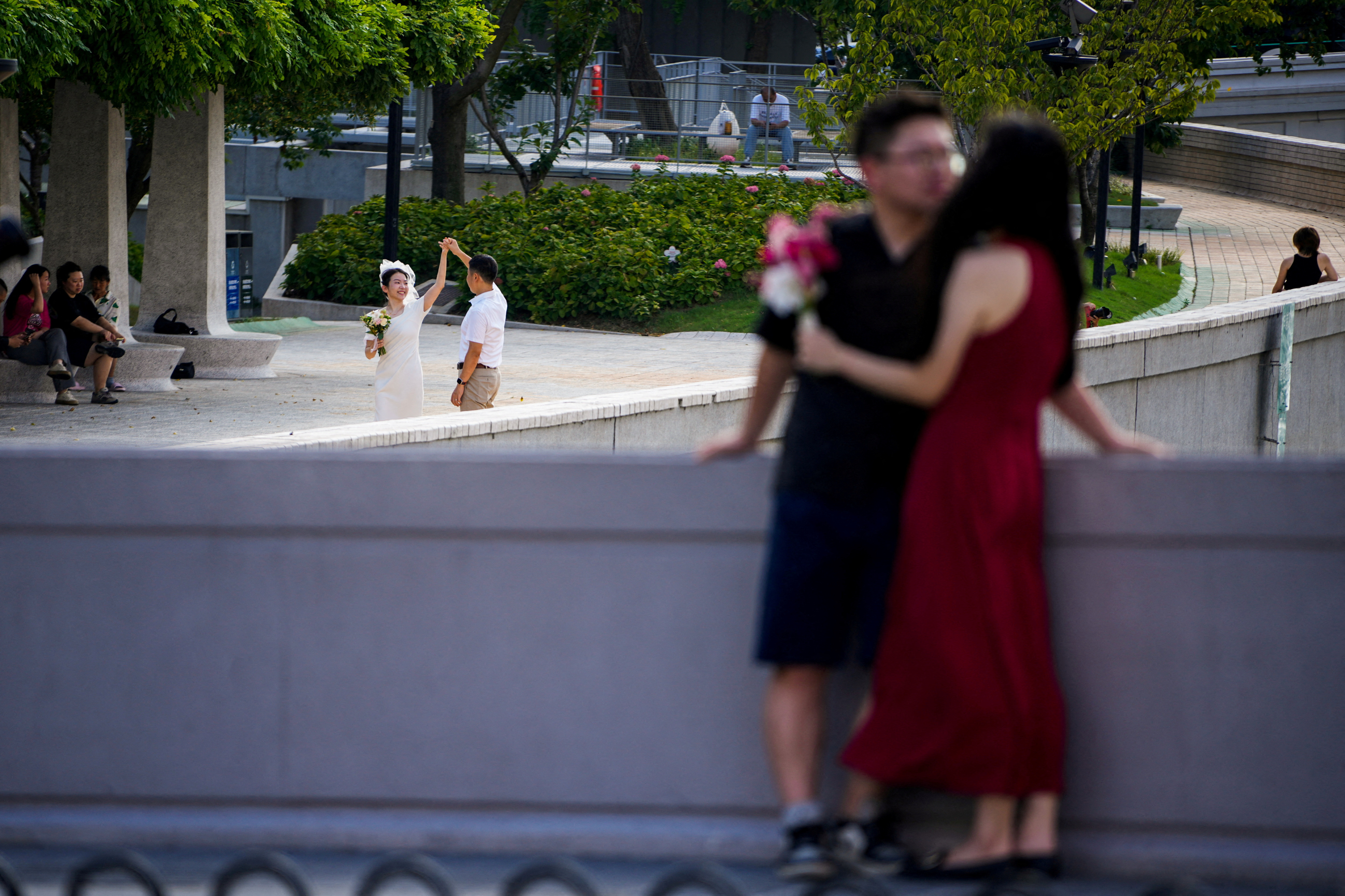 FILE PHOTO: Couples prepare to get their photo taken during a wedding photography shoot on a street, in Shanghai