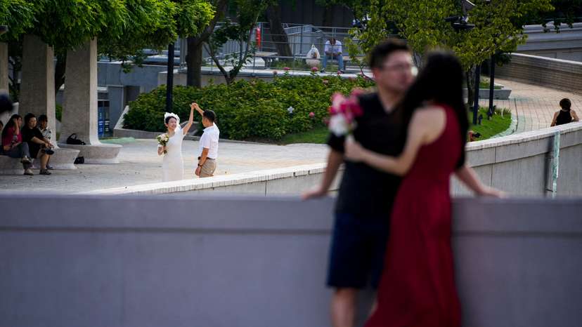 FILE PHOTO: Couples prepare to get their photo taken during a wedding photography shoot on a street, in Shanghai
