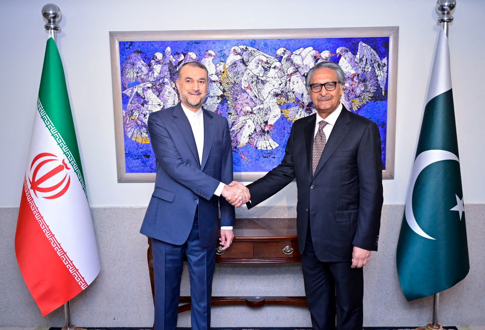 Pakistan's Jilani shakes hands with Iran's Amir-Abdollahian in Islamabad
