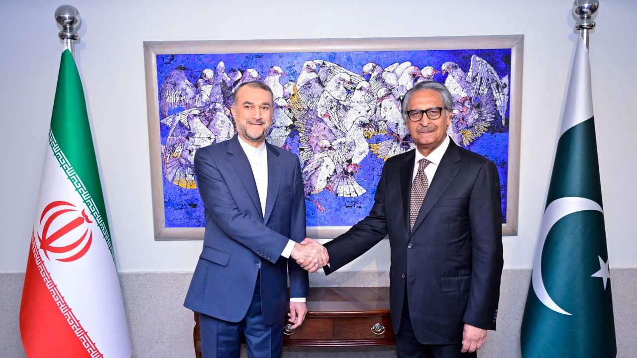 Pakistan's Jilani shakes hands with Iran's Amir-Abdollahian in Islamabad