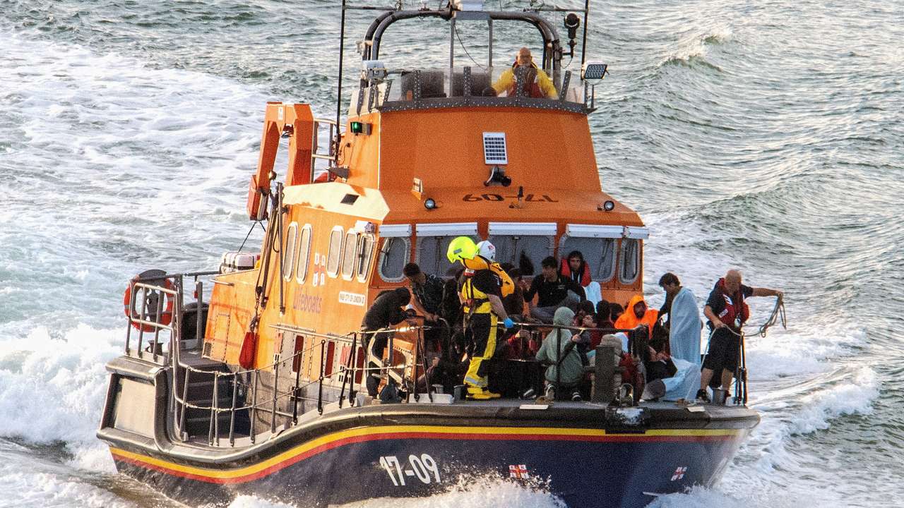 FILE PHOTO: Migrants rescued from the English Channel while crossing from France arrive in Dover