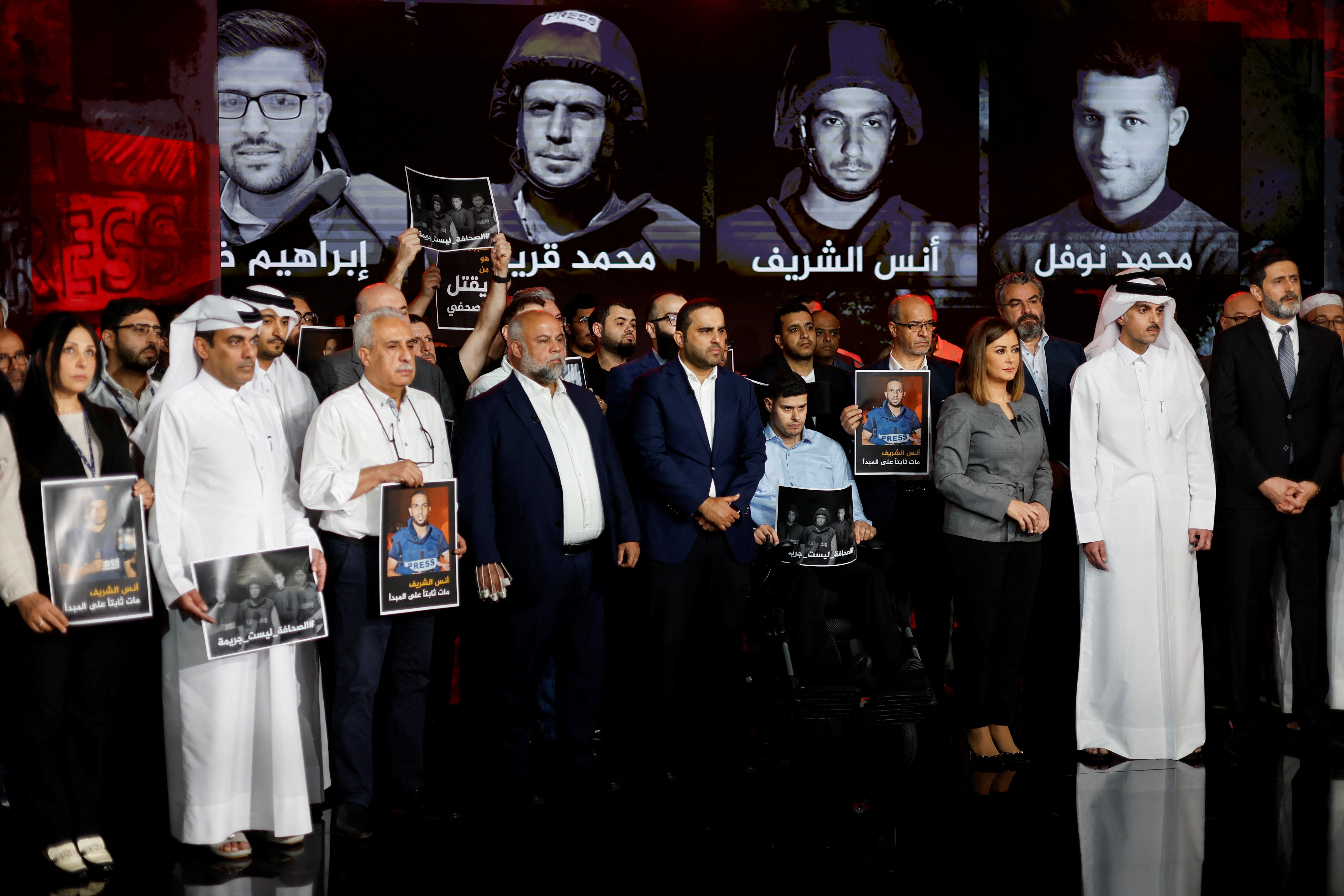 Al Jazeera staff members gather at the network’s studios to remember their colleagues killed in Gaza City by an Israeli strike, in Doha