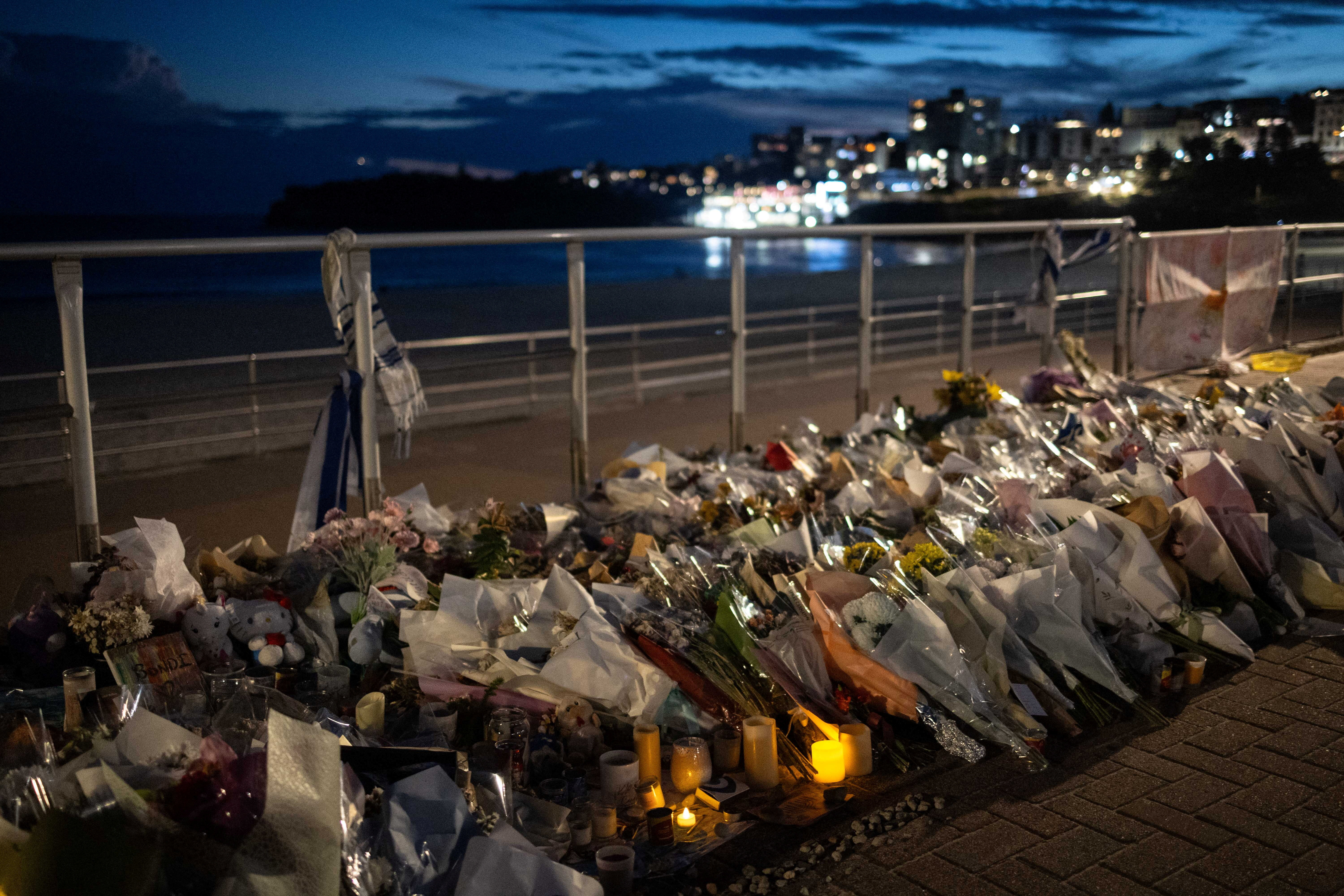 People honour the victims of a mass shooting during a Jewish Hanukkah celebration at Bondi Beach