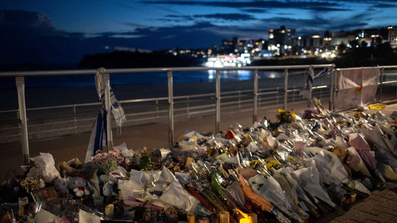 People honour the victims of a mass shooting during a Jewish Hanukkah celebration at Bondi Beach