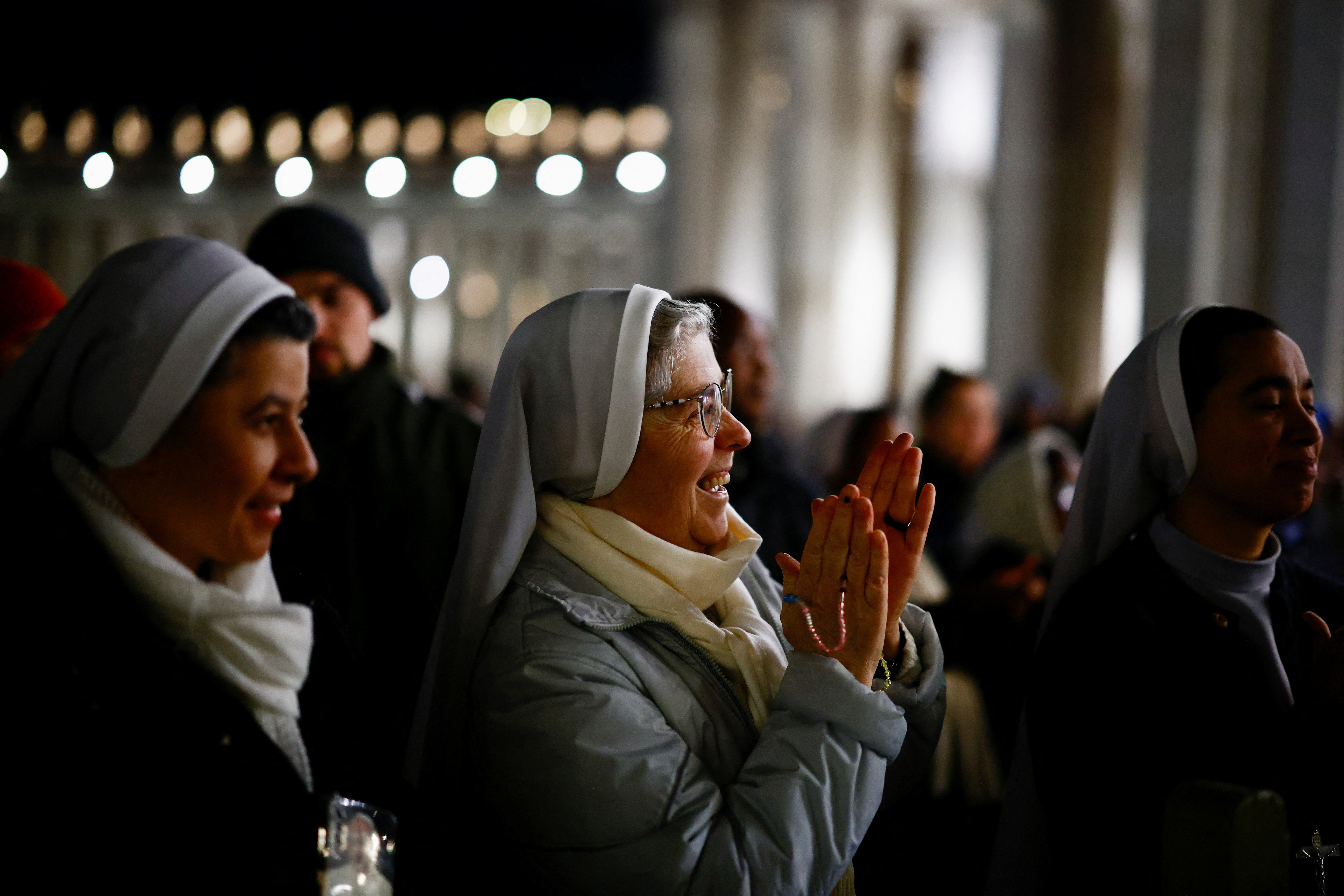 Faithful listen to an audio message by Pope Francis at the Vatican