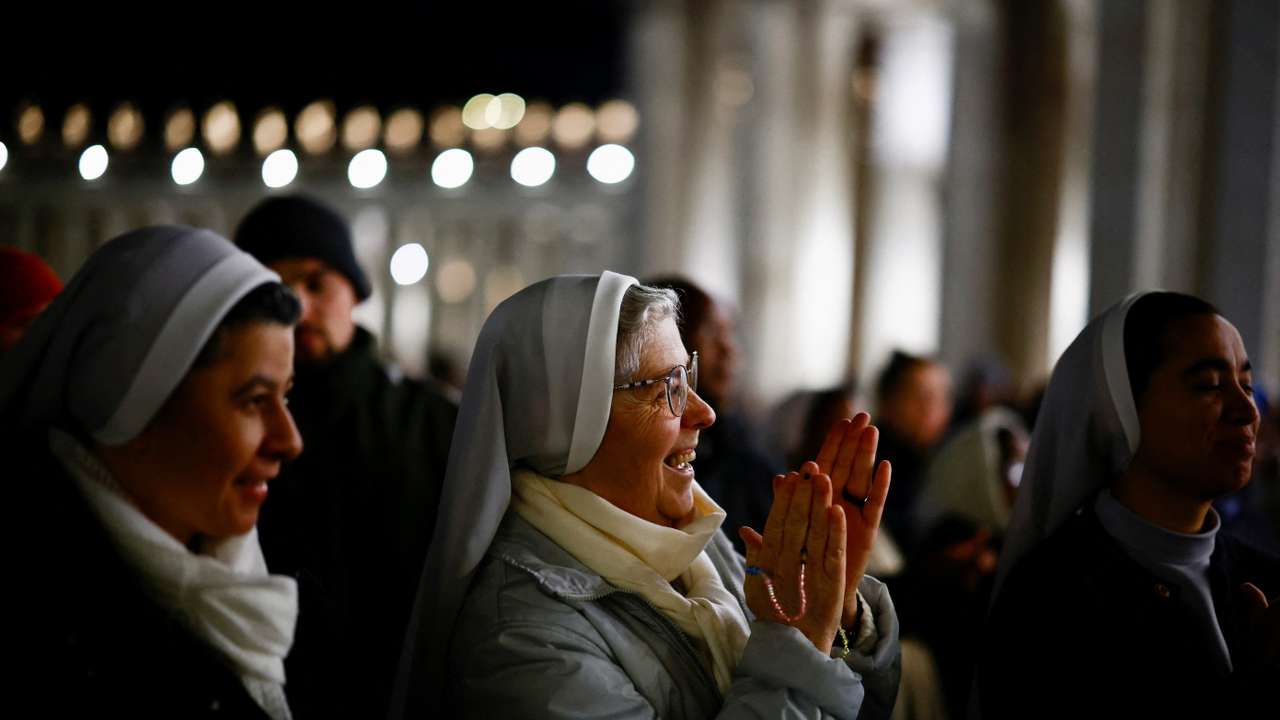 Faithful listen to an audio message by Pope Francis at the Vatican