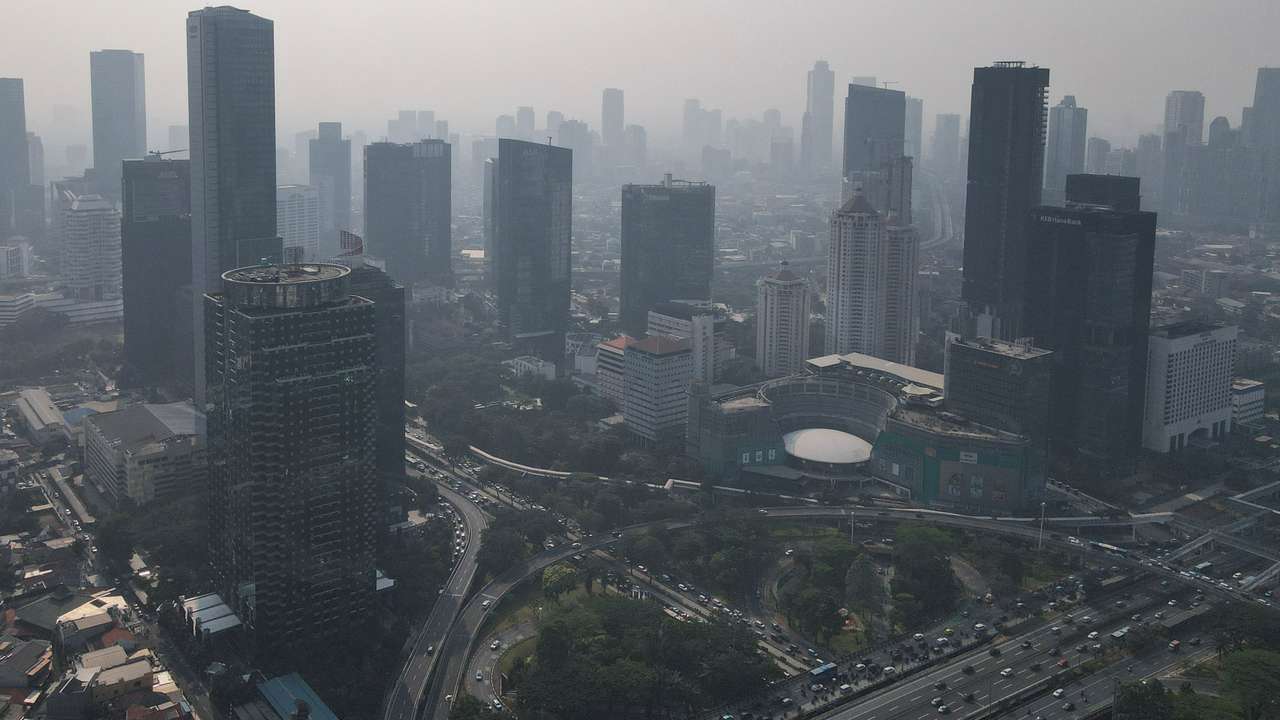 General view of high-rise buildings shrouded in smog in Jakarta