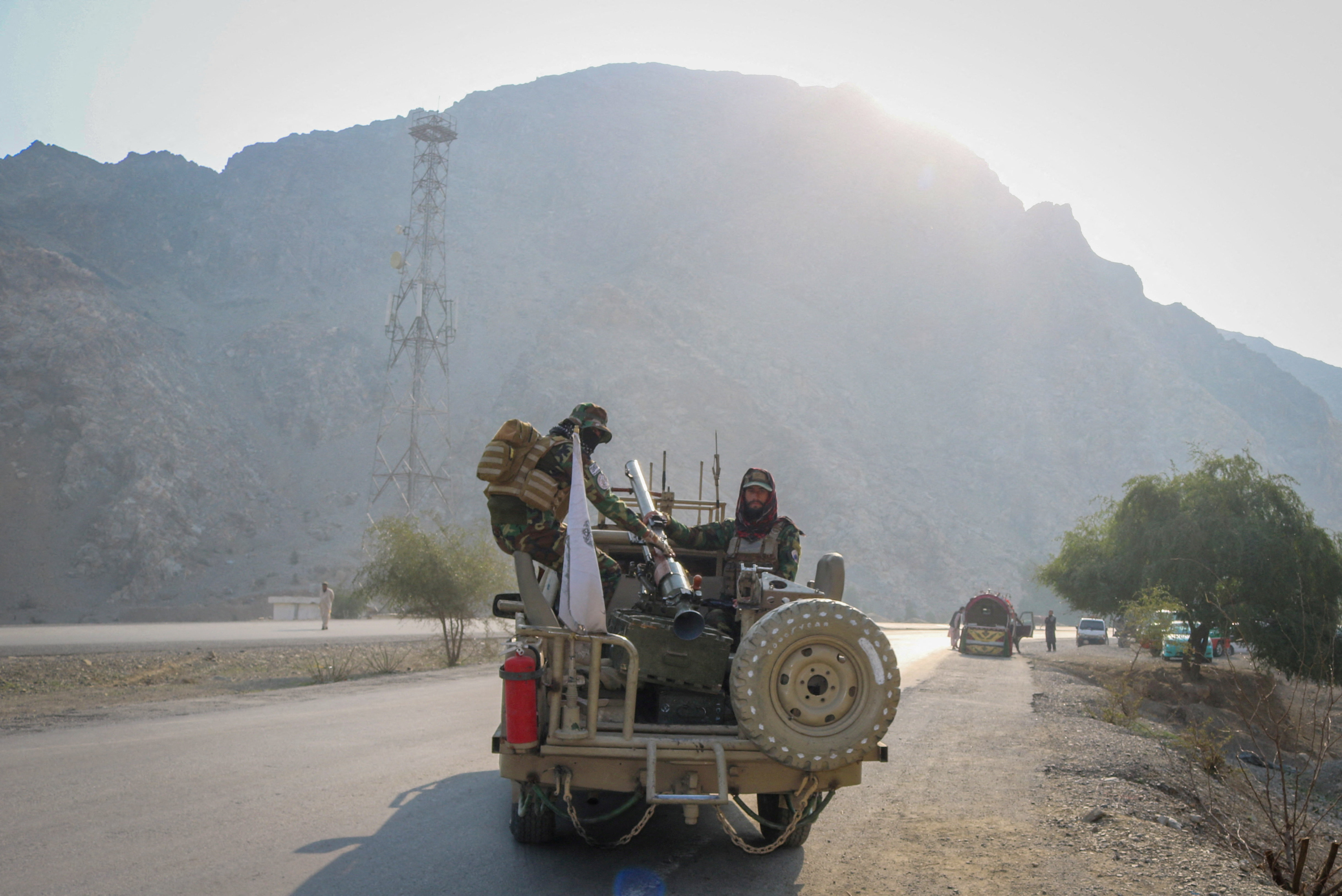 Taliban soldiers carry rocket launcher in a vehicle near Torkham border
