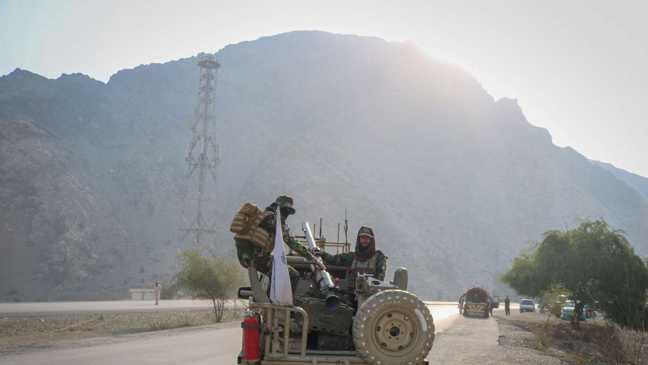 Taliban soldiers carry rocket launcher in a vehicle near Torkham border