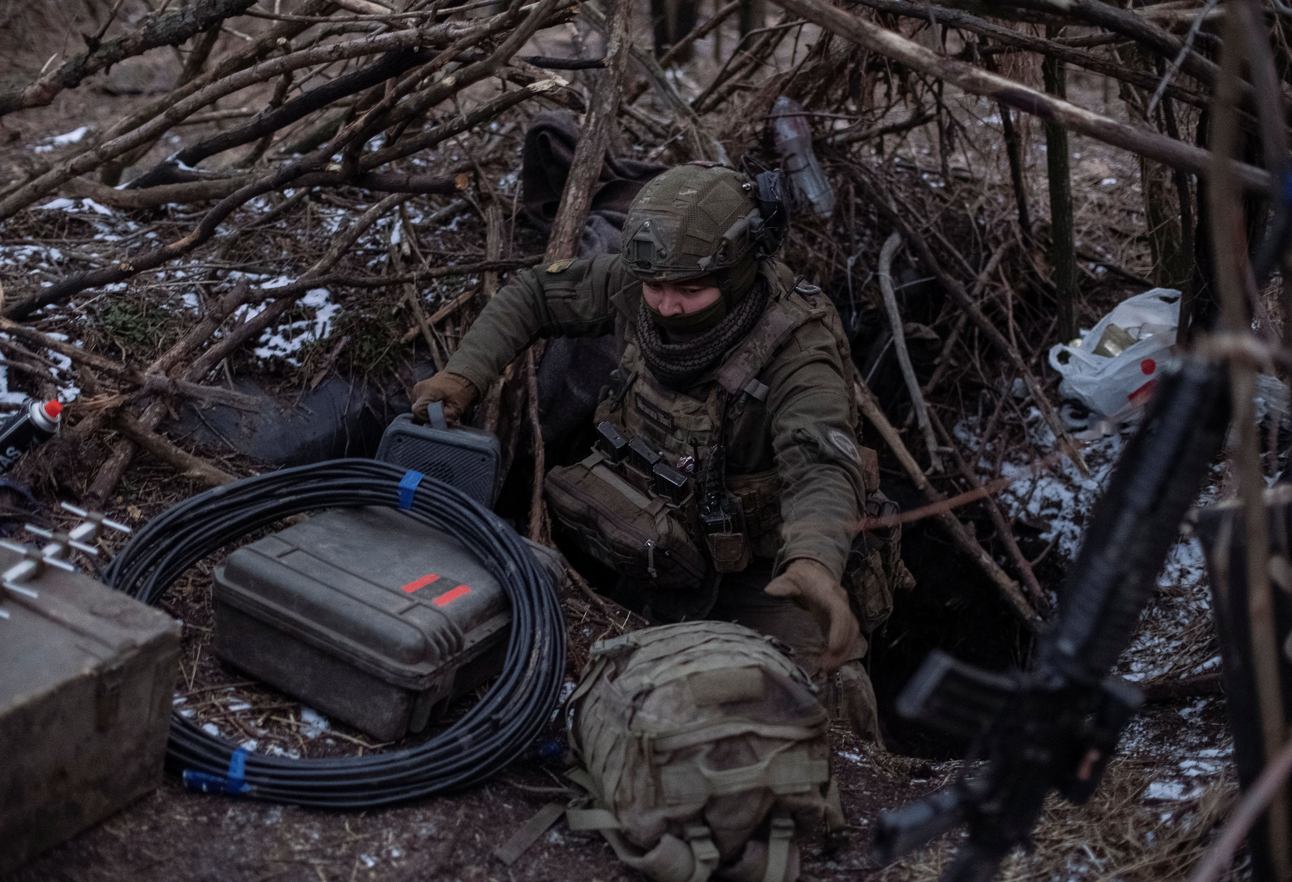 A Ukrainian serviceman prepares his position to operate a drone at a front line near the town of Avdiivka