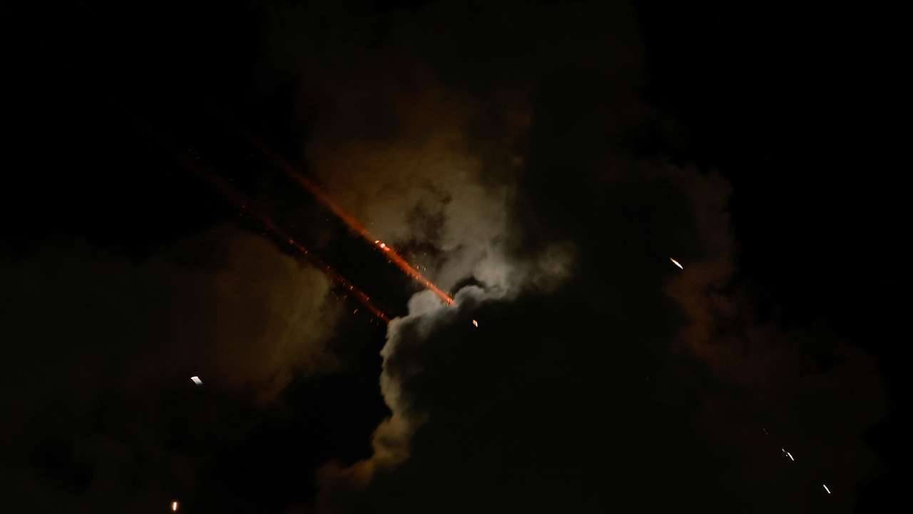 Rockets fly in the sky, amid cross-border hostilities between Hezbollah and Israel, as seen from Tel Aviv