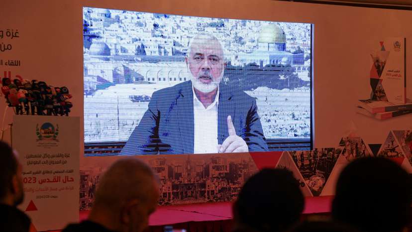 FILE PHOTO: Hamas leader, Ismail Haniyeh, speaks in a pre-recorded message shown on a screen during a press event for Al Quds International Institution in Beirut