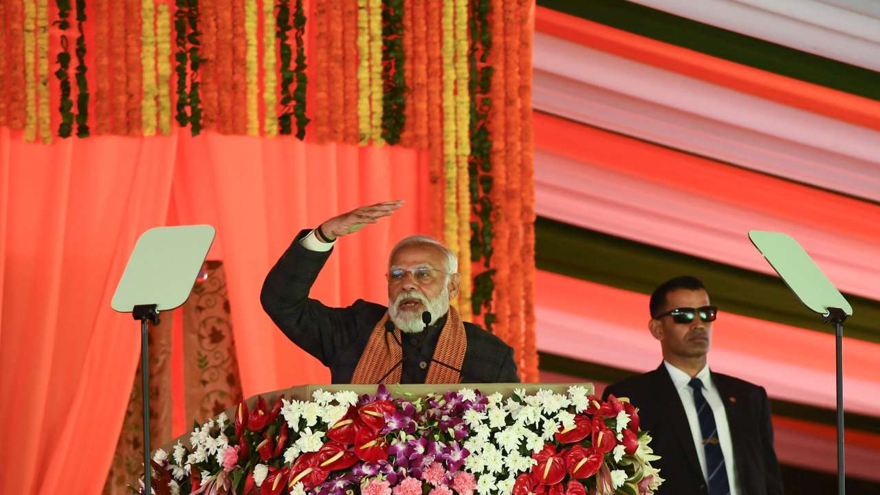 India’s Prime Minister Narendra Modi speaks during a rally, as his bodyguard looks on at the Bakshi Stadium in Srinagar