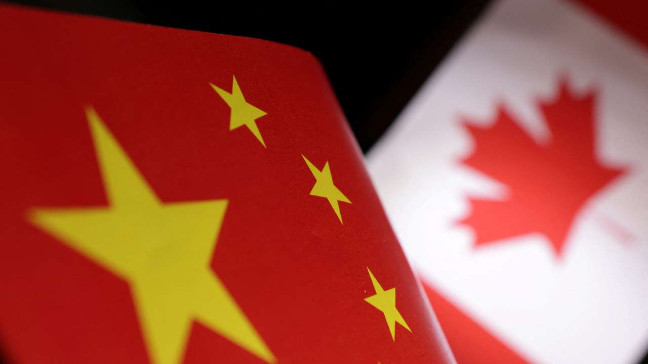 Illustration shows printed Chinese and Canada flags