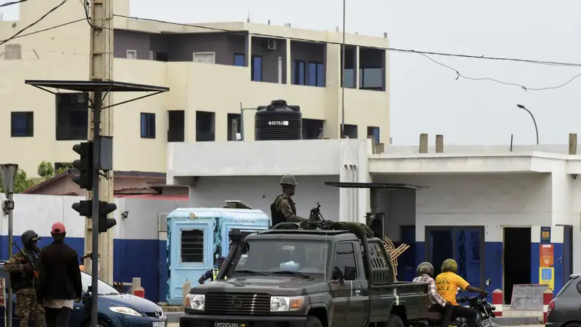 Military vehicles take position, in a street in Cotonou