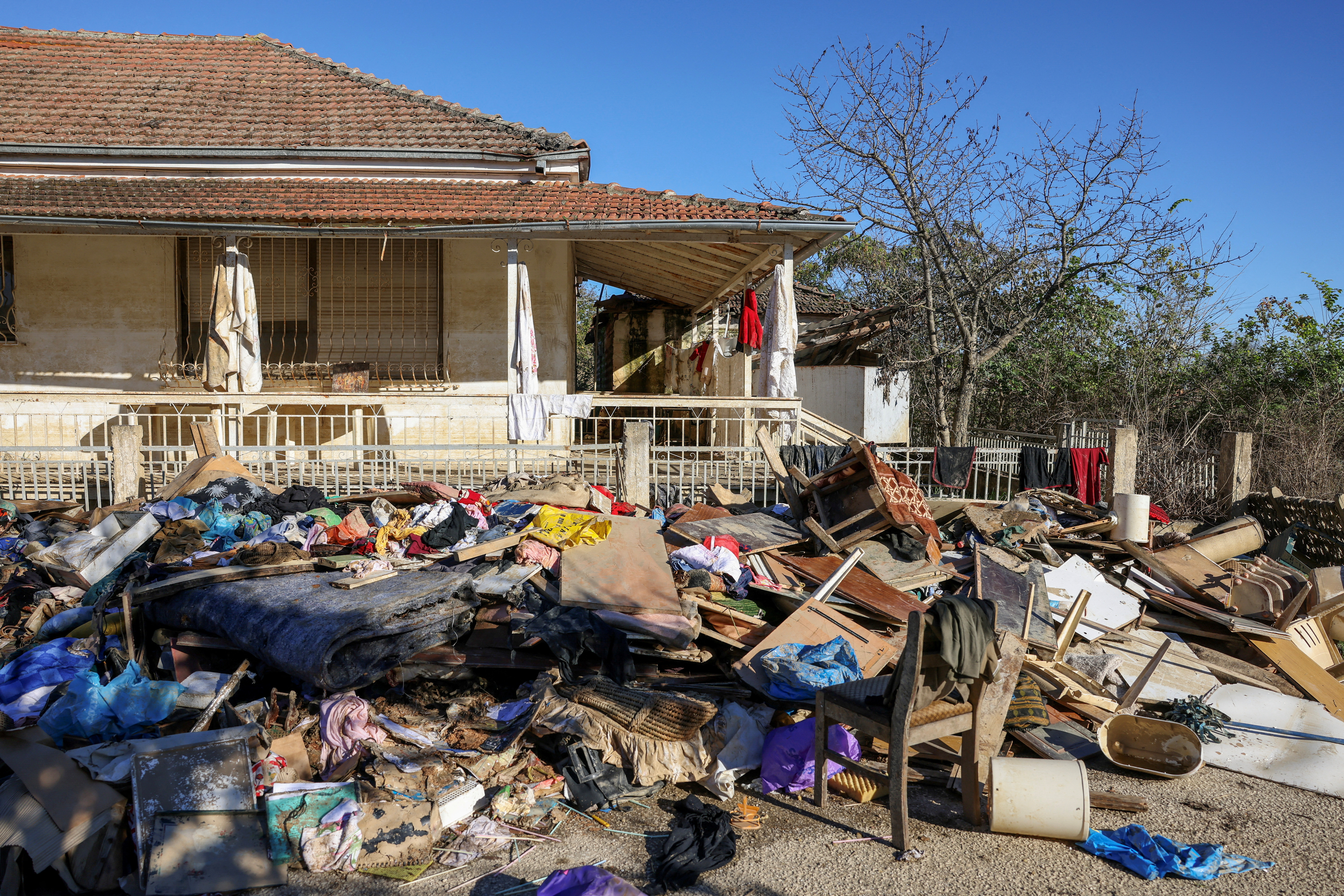 FILE PHOTO: Clothes, furniture and other belongings of locals are pictured piled up outside a house, in the aftermath of Storm Daniel, in the village of Metamorfosi