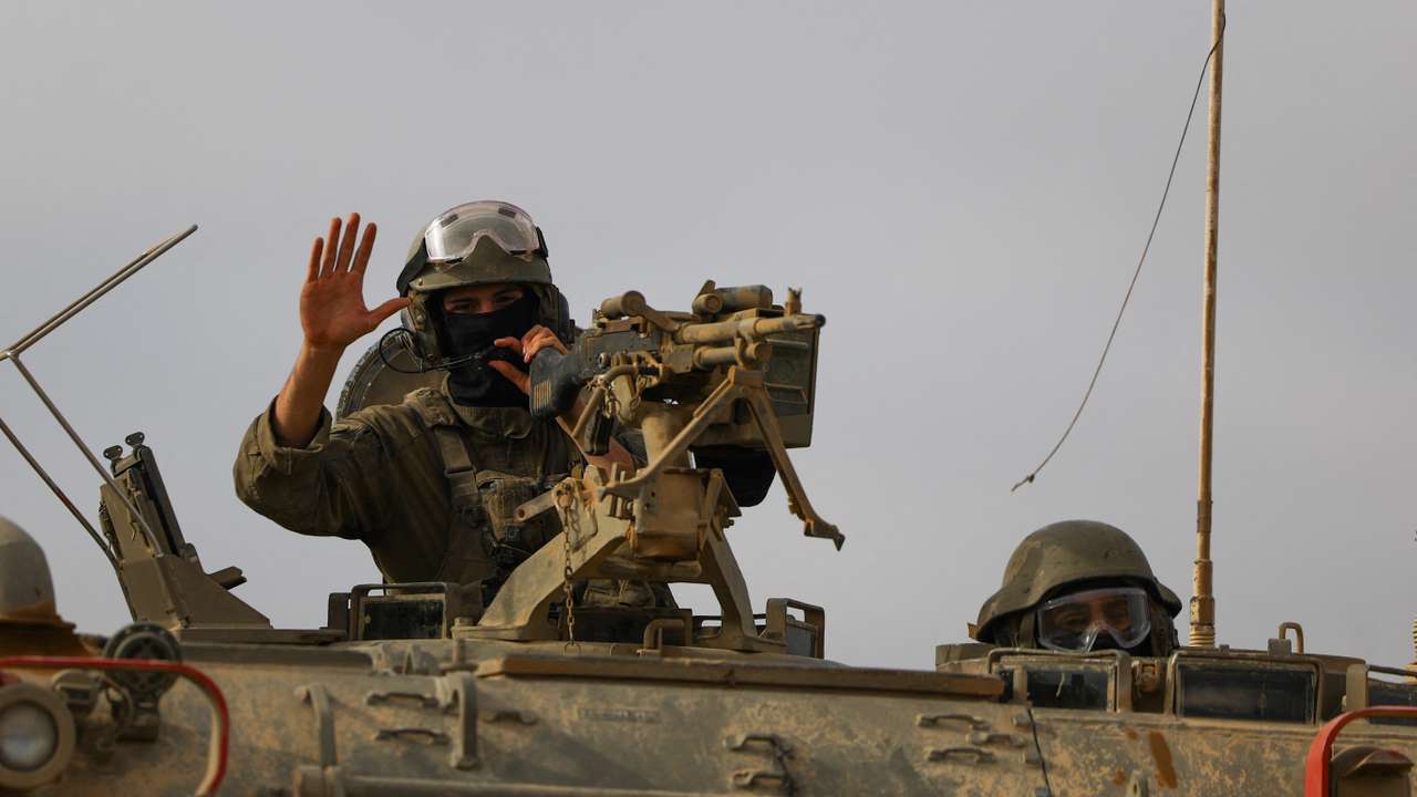 Israeli military personnel drive near the Israel-Gaza border
